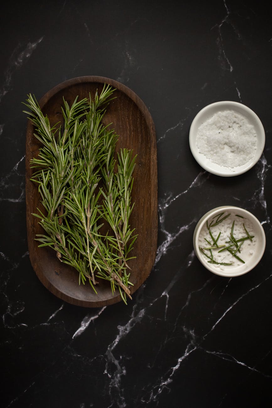 fresh rosemary placed on a wooden plate