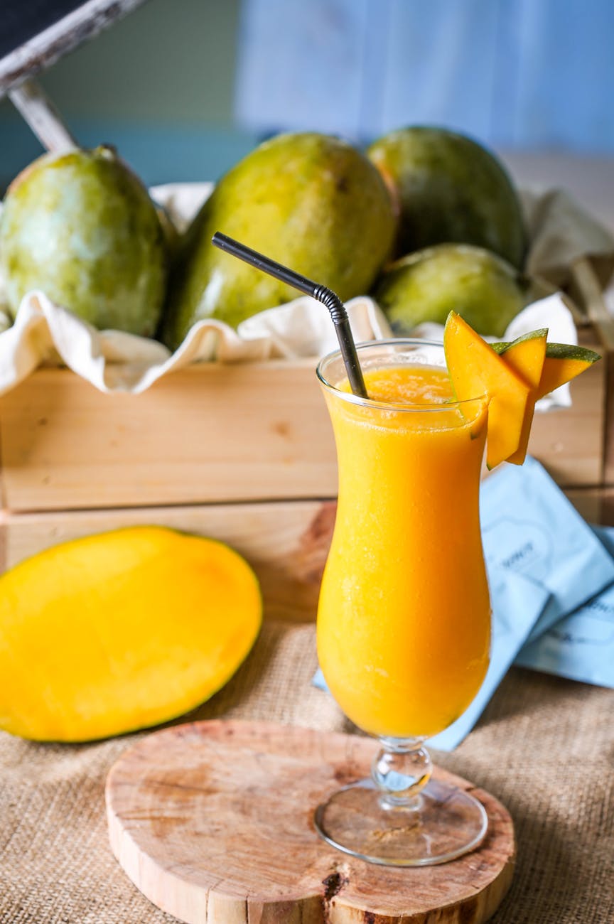 yellow juice in clear drinking glass