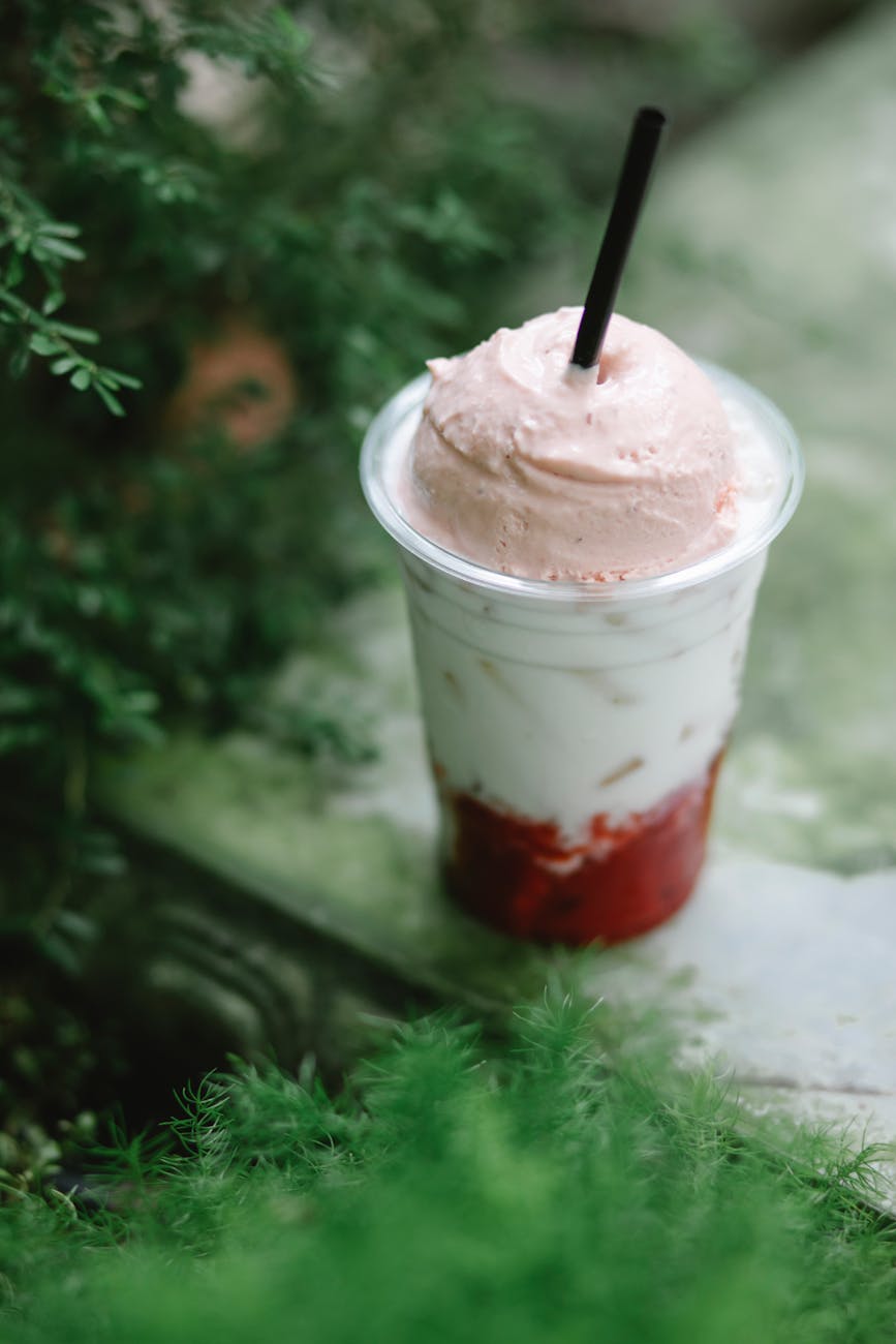 milkshake with tasty cold ice cream in plastic cup